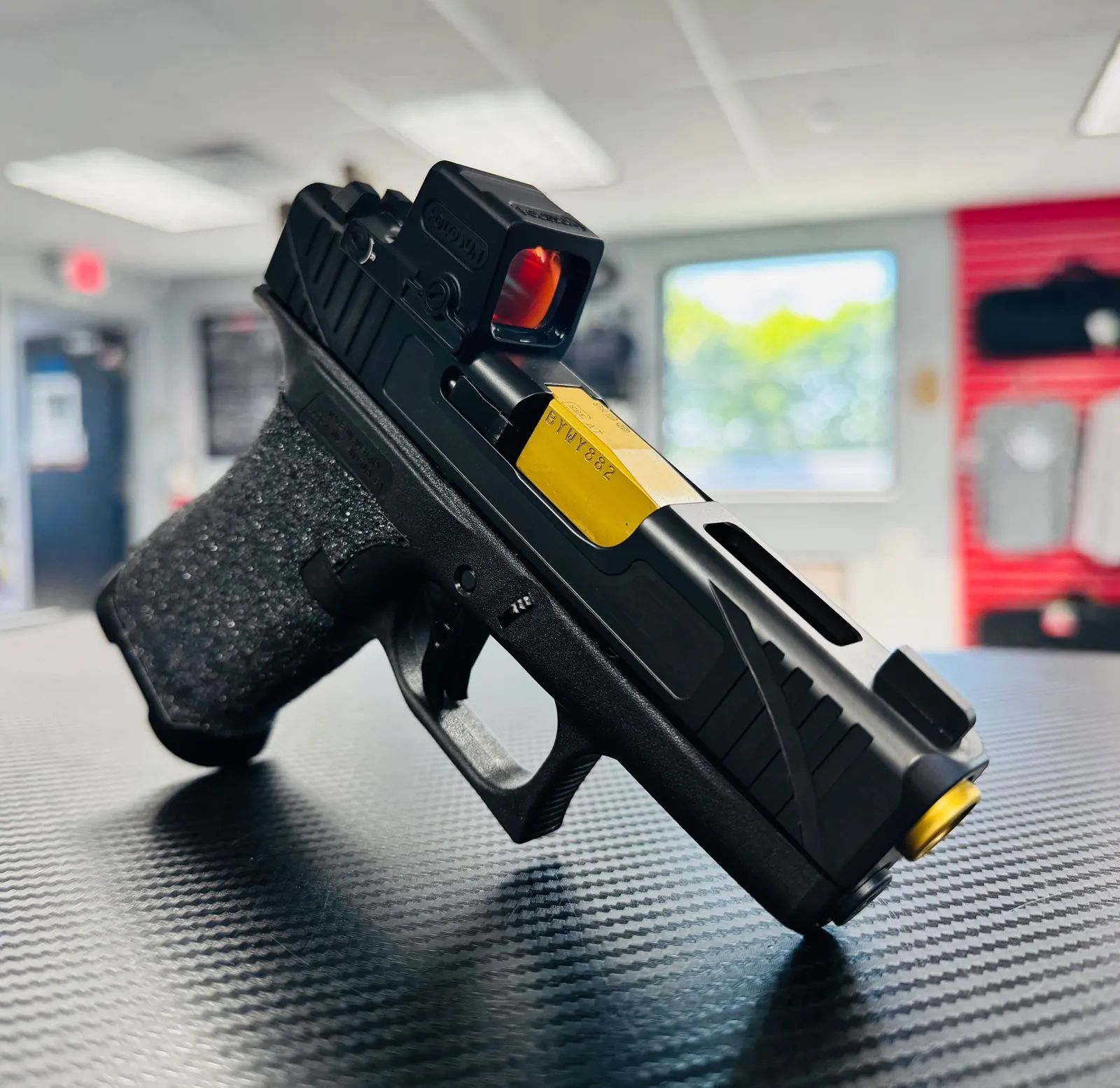 Glock with gold barrel and stippled frame