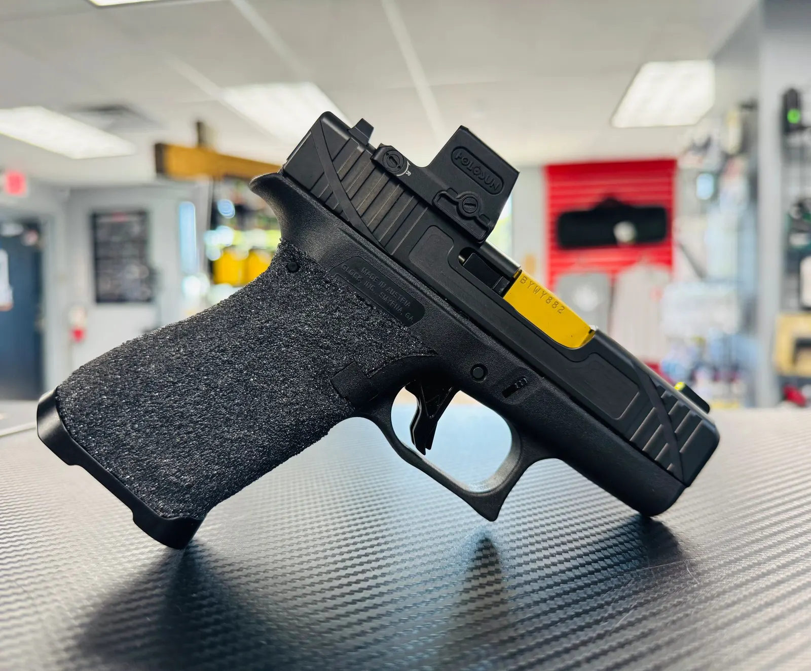 Pistol with red dot on a shop counter